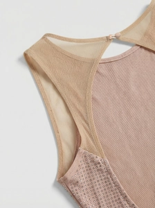 Détail de la robe en maille rose avec strass argentés et tissu côtelé délicat
