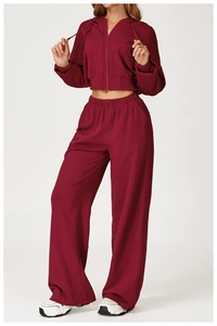 Detail of burgundy high-waisted wide-leg sweatpants and zip-up hoodie set