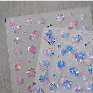 Detailed macro view of laser holographic firework and star nail art stickers with 3D effect