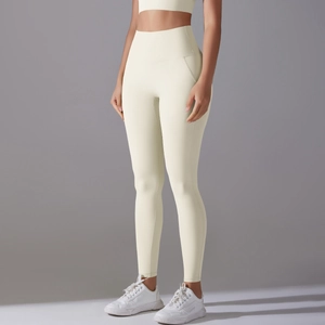 Detail of high-waist cream yoga leggings showing tummy control and seamless fabric fit