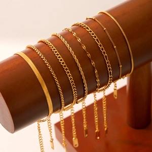 Detailed display of 18K gold plated stainless steel snake, figaro and twisted chains