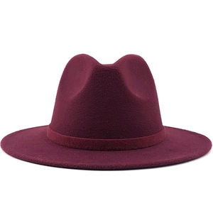 Close-up of wine red fedora hat with a flat brim and matching ribbon trim detail