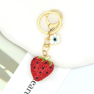 Macro view of sparkling strawberry keychain with red and black rhinestones