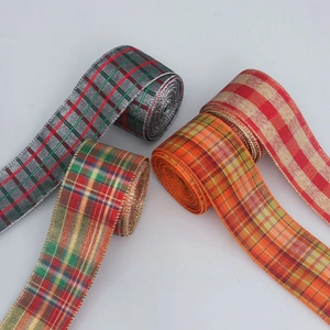 Detail of plaid ribbons with gold wire edges in multiple festive color patterns