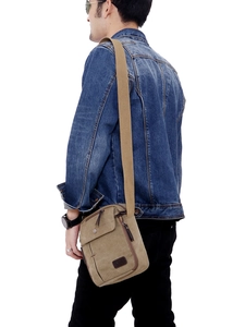 Khaki canvas messenger bag for men with adjustable strap shown on model side view