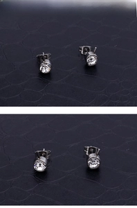 Close-up of silver stainless steel stud earrings with round clear crystal stones