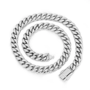 Macro view of silver stainless steel Cuban chain with sparkling zircon cross buckle detail