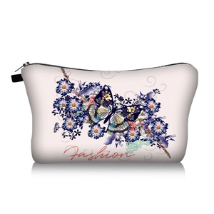 Detail of butterfly and flower print on a beige trapezoid travel toiletry bag with zipper