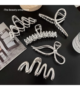Detailed set of six silver metal hair clips with wavy, bow, and geometric patterns