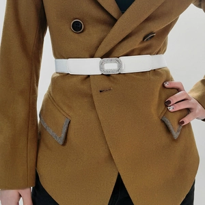 Close-up of a white elastic waist belt featuring a luxury square rhinestone buckle for women