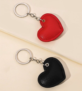 Close-up of heart-shaped PU leather keychains with litchi texture and silver chains