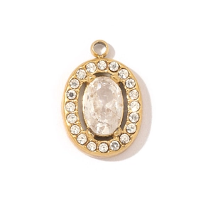 Macro shot of oval gold stainless steel pendant with sparkling zircon gemstones