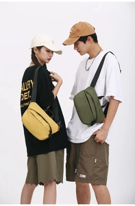 Detail view of large capacity crossbody chest bags in yellow and olive green nylon fabric