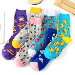 Set of five cotton socks with colorful fruit and art patterns in a flat lay view