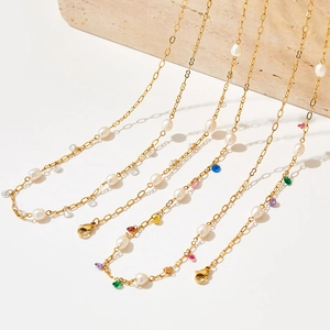 Elegant gold pearl bracelet with colorful zircon beads on a minimalist stone base