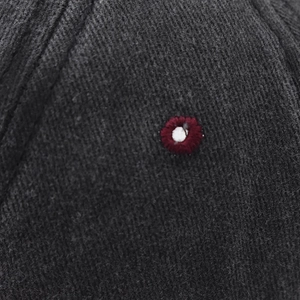 Macro detail of high-quality washed charcoal cotton twill fabric with round embroidery