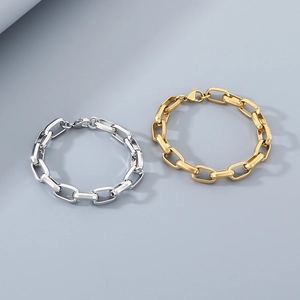 Detailed view of square link chain bracelets in gold and silver minimalist finishes