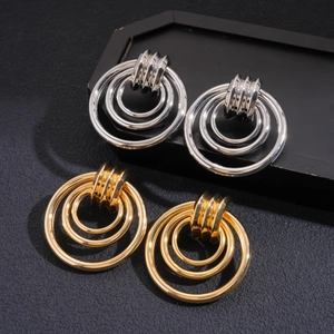 Modern hollow circular tiered metal earrings in polished gold and silver finishes