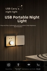 Close-up of a warm LED USB night light plugged into a socket with a cozy glow