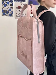 Pink faux leather laptop backpack featuring cute cat ear pockets and a minimalist design