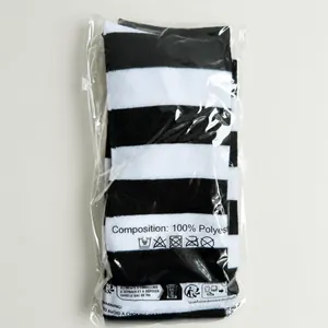 Detail of black and white striped over-the-knee socks in clear packaging made of polyester