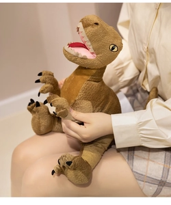 Close-up of soft plush T-Rex toy being held to show texture and realistic dinosaur detail