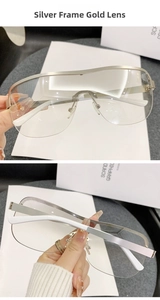Detail of silver frame cycling sunglasses with gold lenses and white temples