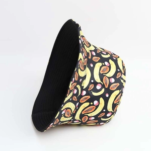 Fashionable reversible bucket hat with colorful fruit print and solid black inner side