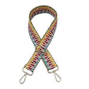Close-up of a 3.8cm colorful geometric embroidered crossbody strap with gold metal buckles