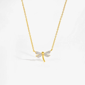 Close-up of golden dragonfly pendant necklace with sparkling clear rhinestones on wings