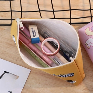 Close-up of high-capacity yellow astronaut pencil case showing internal storage with pens