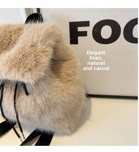 Detail of fluffy faux fox fur backpack in beige with black drawstring closure