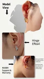 Detail view of gold and silver C-shape earrings with zircon inlay on female model