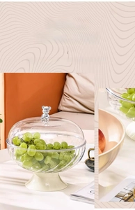 Detail of high-transparency fluted glass fruit bowl with silver bear handle