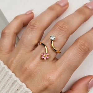 Minimalist gold open ring featuring a pink enamel flower and sparkling zircon crystal