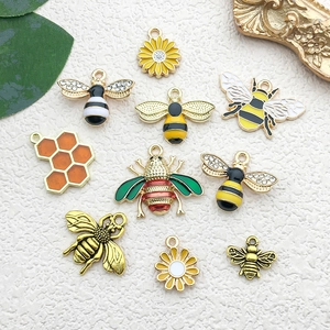 Detailed view of DIY bee and sunflower alloy charms with colorful enamel finish