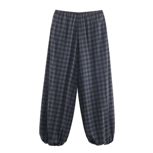 Detailed view of elastic waist and black-grey plaid pattern on cotton lantern pants