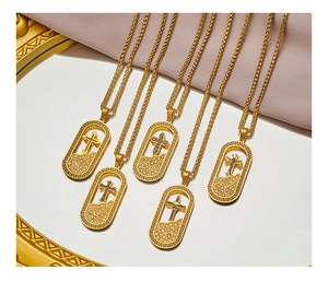 Detail of five 18K gold plated cross pendant necklaces with rhinestones on silk