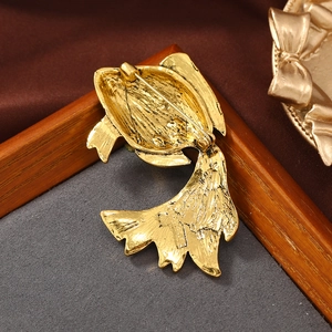 Detailed back view of gold goldfish brooch showing the metal pin clasp and texture
