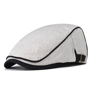 Detail of adjustable metal buckle and contrast stitching on grey cotton flat cap