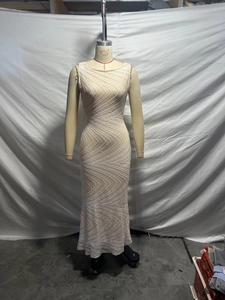 Detail of elegant beige sequined evening dress with wavy patterns and slim fit cut