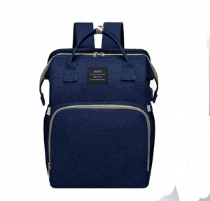 Detail of navy blue waterproof fabric diaper bag with front zipper pocket and logo patch