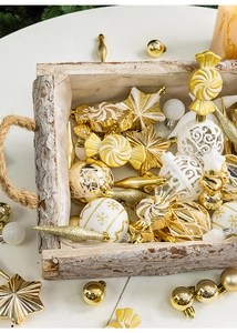Macro detail of gold and white Christmas ornaments in a vintage wooden tray with stars
