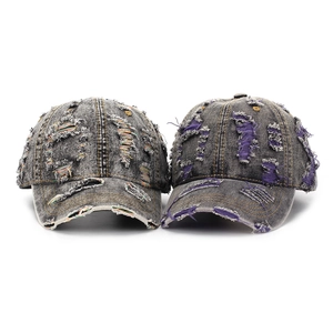 Detail of distressed denim baseball caps with colorful stitching and purple fabric inserts
