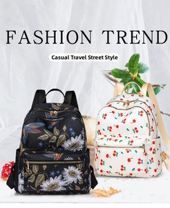 Detail view of floral and cherry print waterproof nylon backpacks with gold zippers