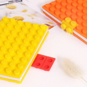 Mini A6 silicone notebook with yellow and orange building block cover and red clasp