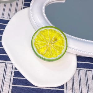 Macro shot of realistic yellow lemon slice decor on a white ceramic tray with striped cloth