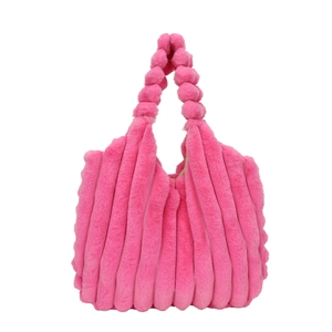 Fuchsia plush tote bag with vertical striped texture and spherical handles on white background