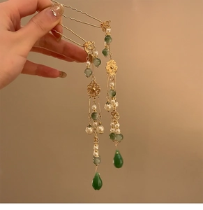 Vue détaillée d'épingles à cheveux chinoises avec perles émeraude et longs glands dorés