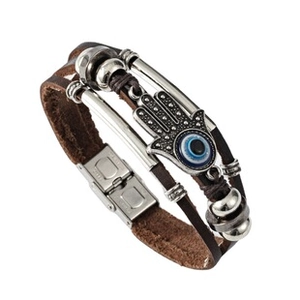 Detail of brown leather multilayer bracelet with Hamsa Hand and blue Evil Eye charm